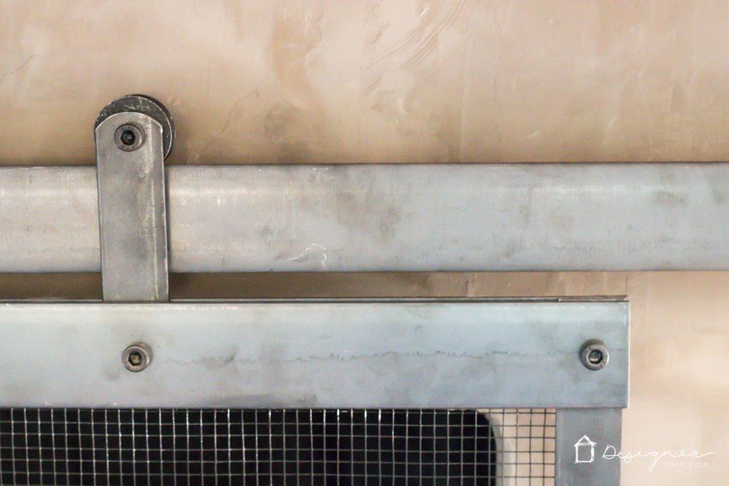 Learn how to make a barn door style fireplace screen without welding! This DIY sliding fireplace screen is easier than it looks to make!