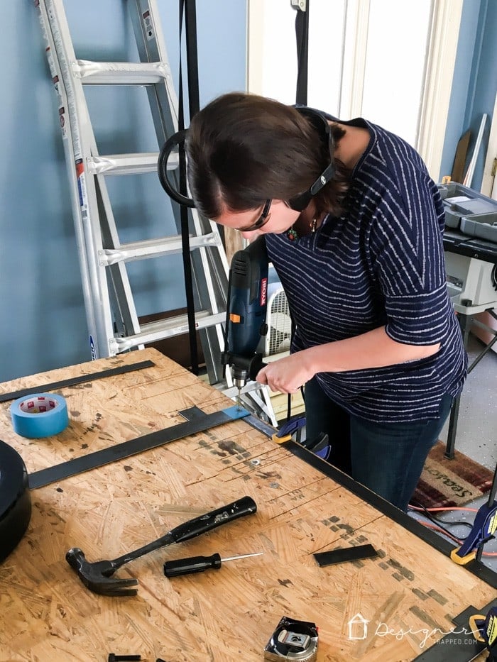 How to Make a Barn Door Style Fireplace Screen | Designertrapped.com Learn how to make a barn door style fireplace screen without welding! This DIY sliding fireplace screen is easier than it looks to make!